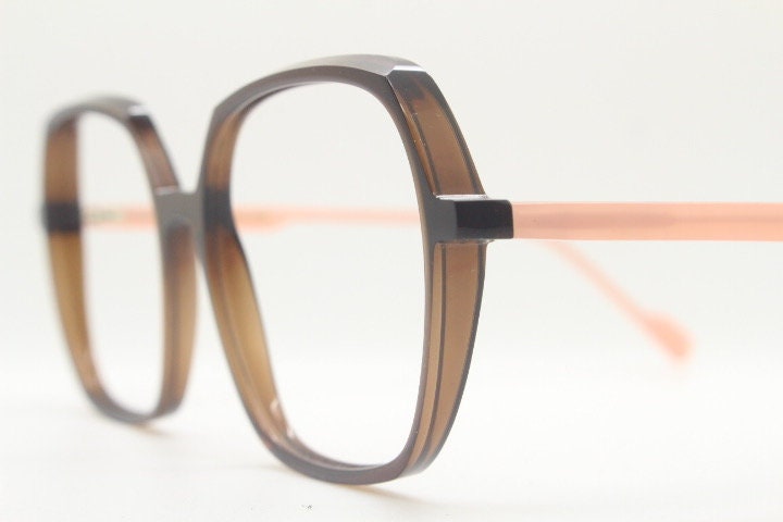Caroline Abram square hexagon eye glasses model Caline. Dark brown acetate optical frame with pink arms. Prescription RX spectacles