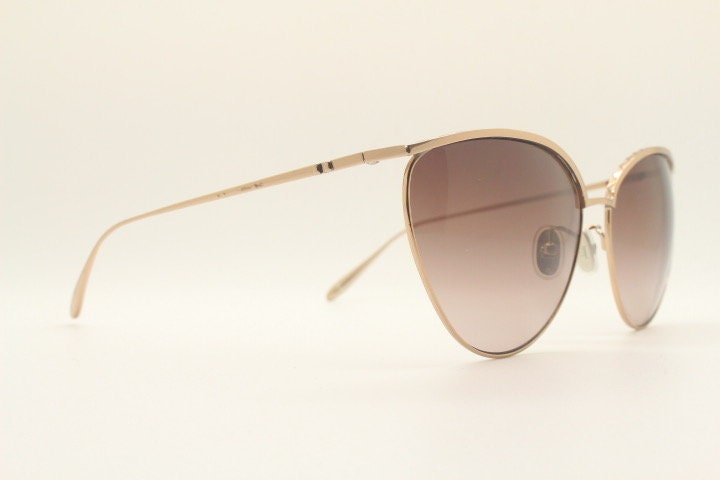 Carolina Herrera minimal cat eye sunglasses model SHN069 made in Italy. Women's gold titanium cateye frame with brown lenses. Vintage NOS
