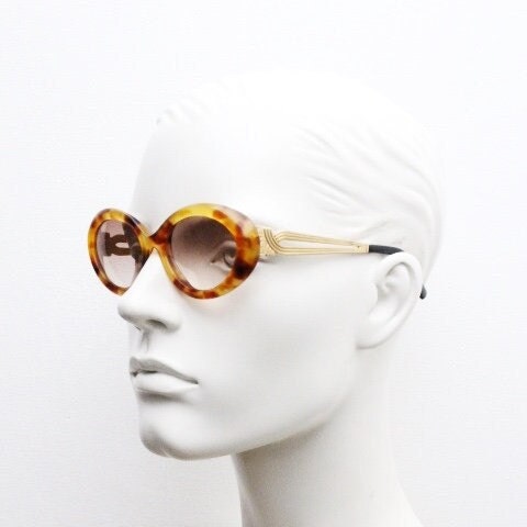 Lanvin 90s vintage chunky oval sunglasses made in France. Mottled honey brown acetate 60s design with detailed arms and light tone lenses