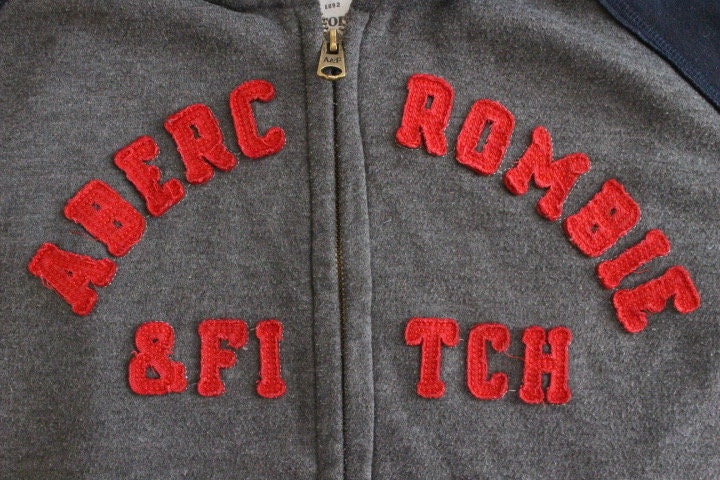 Abercrombie and Fitch grey and blue zipper sweat hoody with large red spell out patch letter chest logo. Mens all cotton medium size