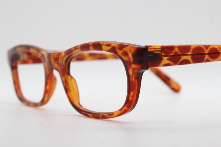 90s vintage rectangular low profile eye glasses. Transparent optical frame with vibrant amber giraffe pattern. Prescription eyeglasses. RX