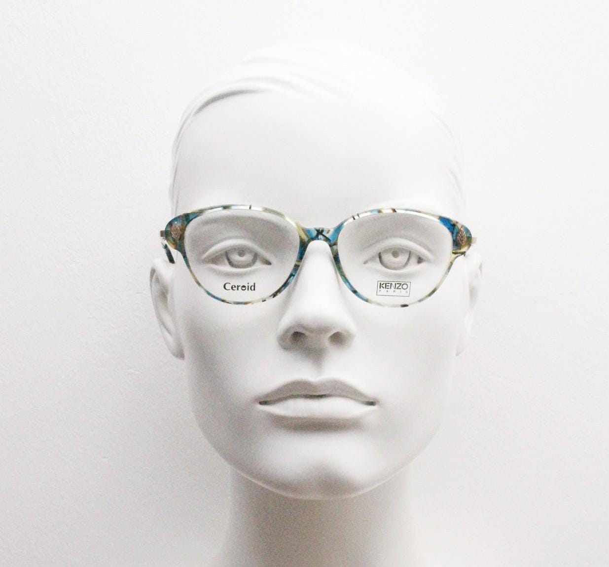 Kenzo 90s vintage cat eye glasses hand made in France. Transparent patterned optical frame with ornate arm details. Womens Prescription. NOS