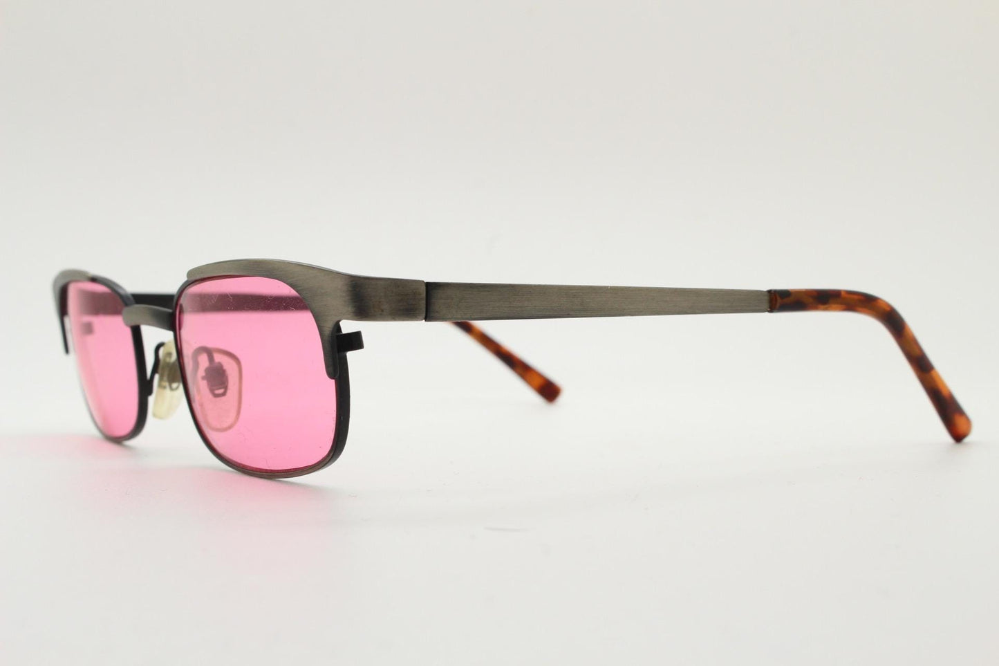 90s vintage rectangular sunglasses with bright pink lenses. Solid metal low profile frame in a brushed bronze finish. Y2K. NOS
