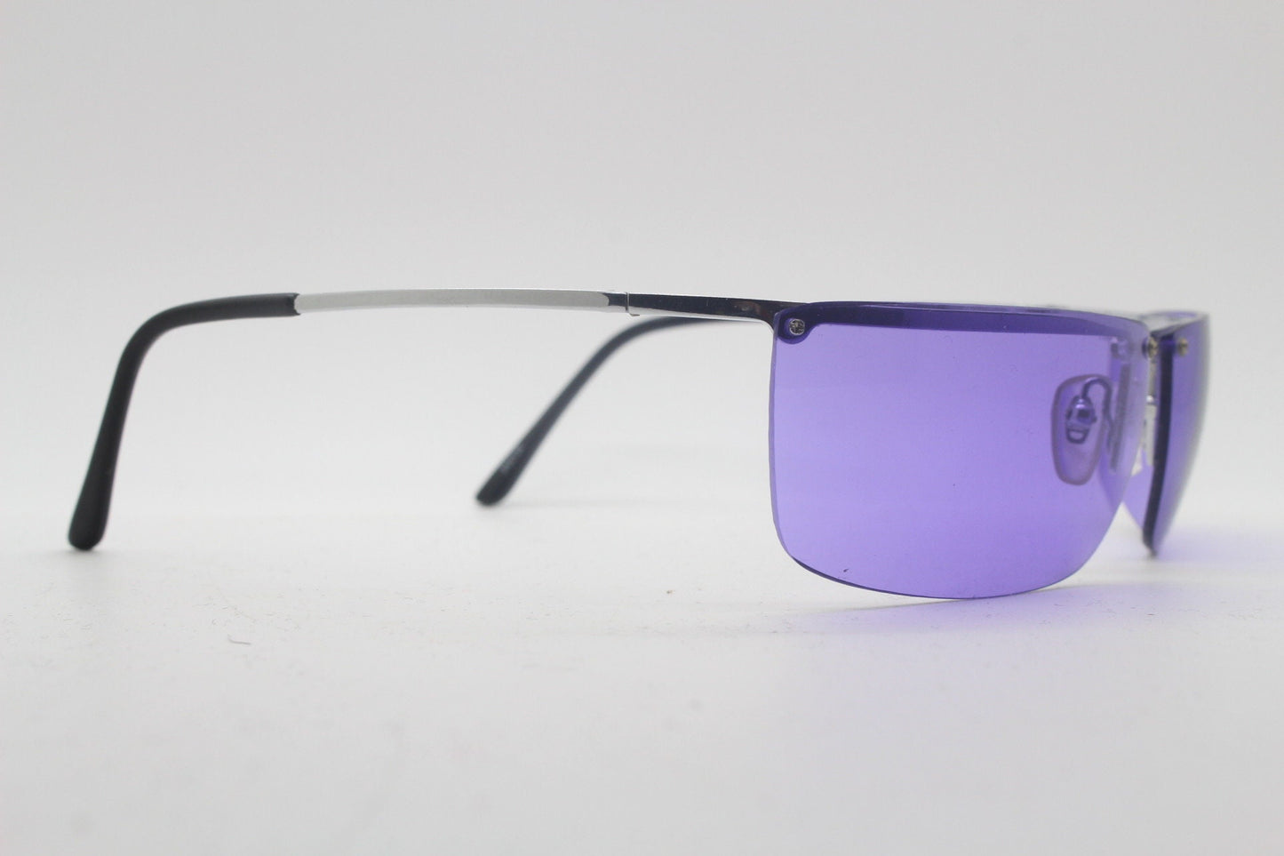 Y2K vintage purple shield sunglasses. 2000's half frame wraparound aerodynamic mini mask visor with curving lenses. 90s 00s unused NOS