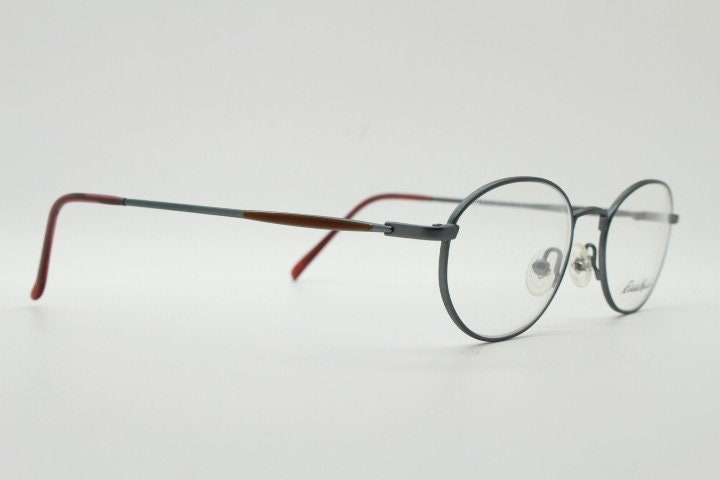 Eddie Bauer 90s vintage oval eye glasses.Grey matt finish optical frames with subtle brown trim. Prescription RX spectacles. NOS