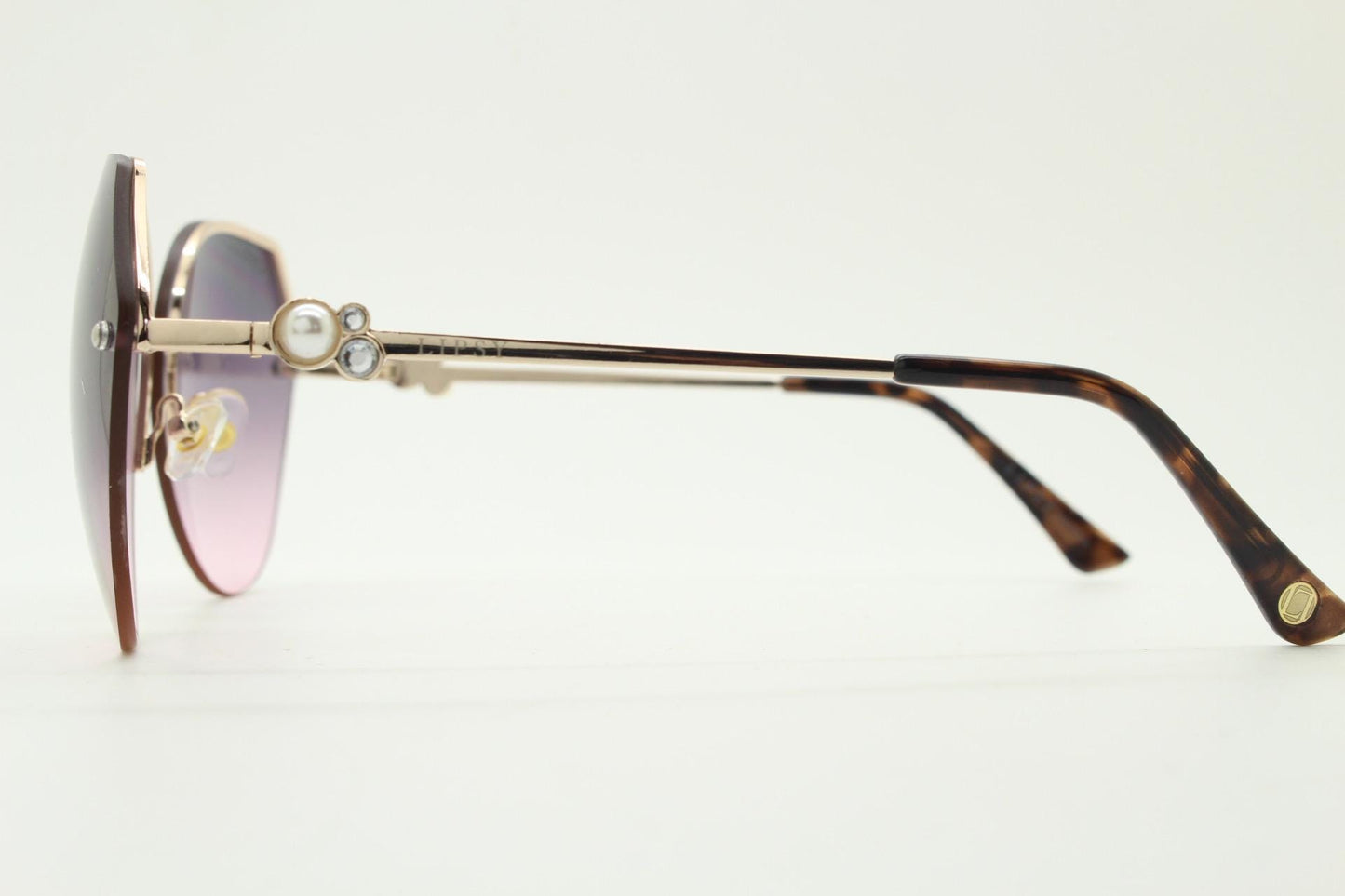 Large rimless sunglasses with dynamic angular grey to pink  graduating lenses. Women's 80s vintage style half frame with gold arms