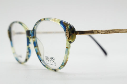 Kenzo 90s vintage cat eye glasses hand made in France. Transparent patterned optical frame with ornate arm details. Womens Prescription. NOS