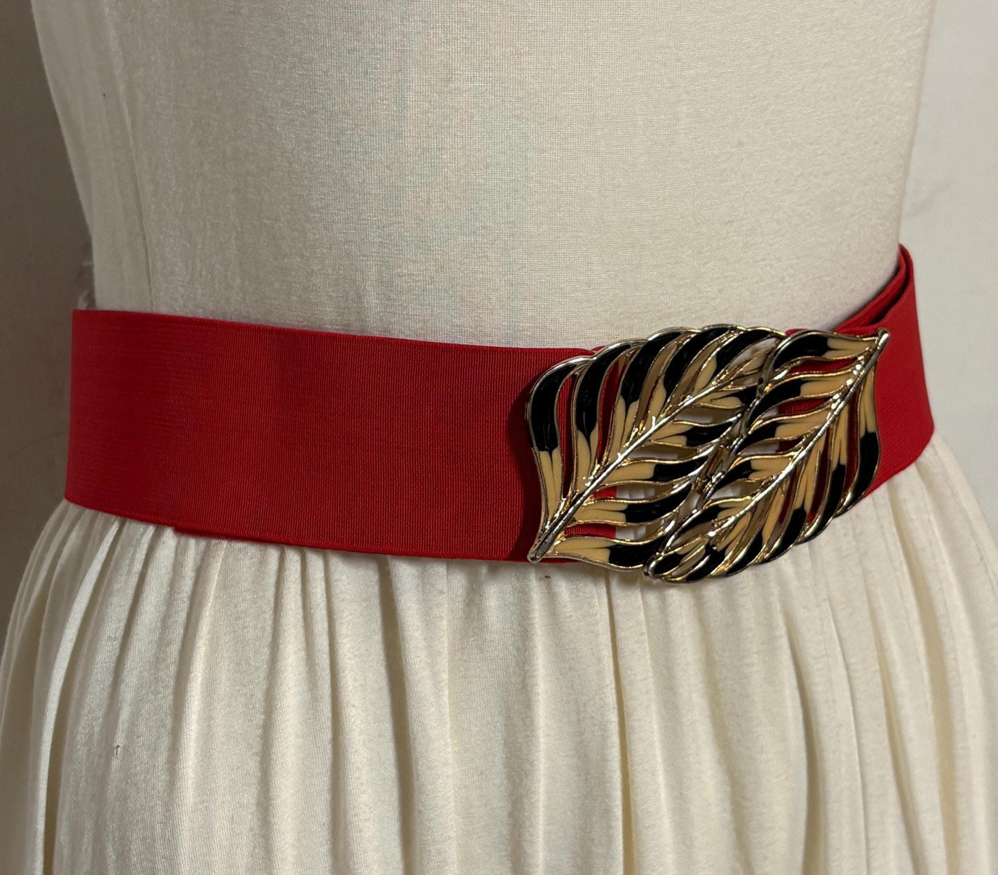 80s vintage womens elastic tall belt. Large exotic palm leaf buckle. Flattering cinch effect. Extensive adjustable size range. Unused NOS
