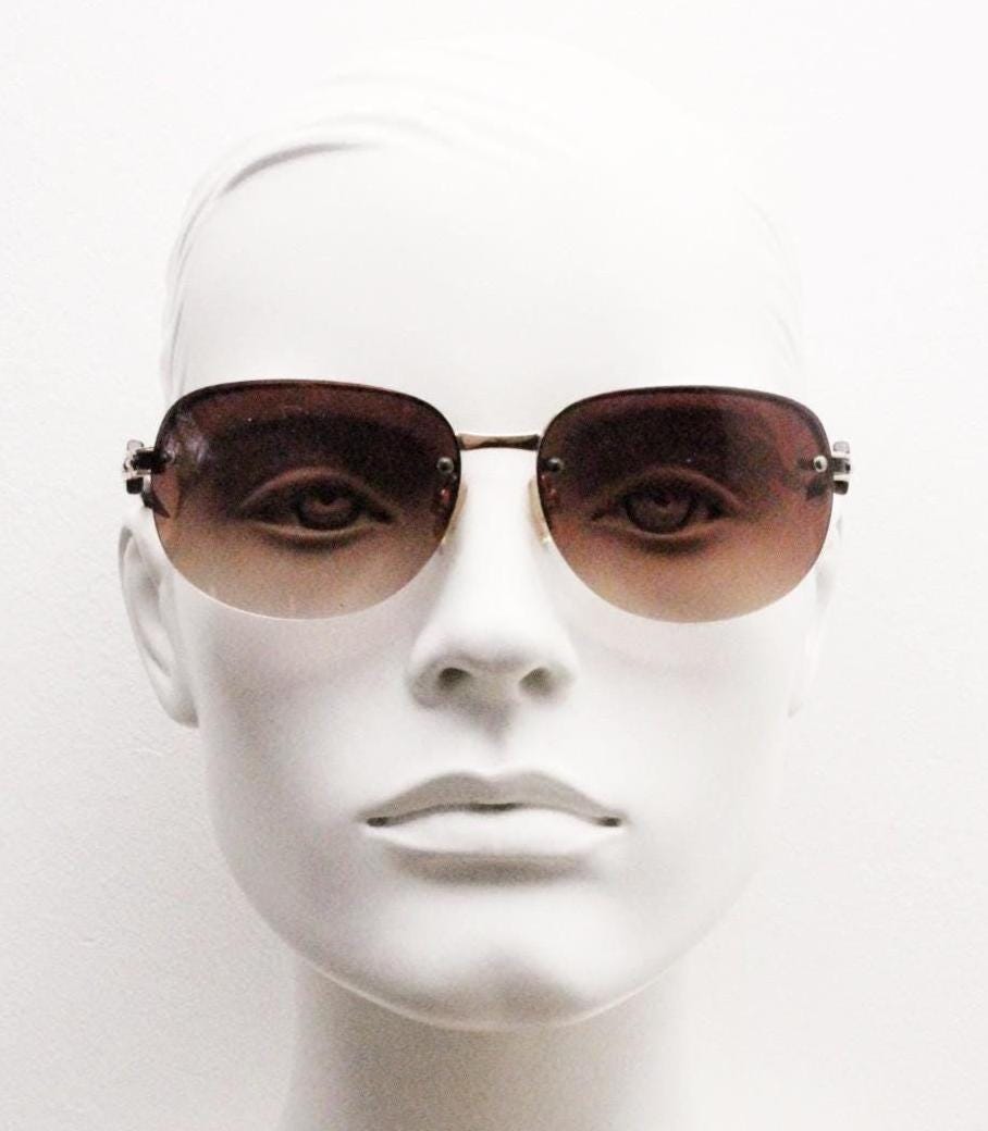 Y2K vintage rectangular brown sunglasses. Gold half frame with tortoise arms, chain link temples and graduating lenses. 2000's NOS