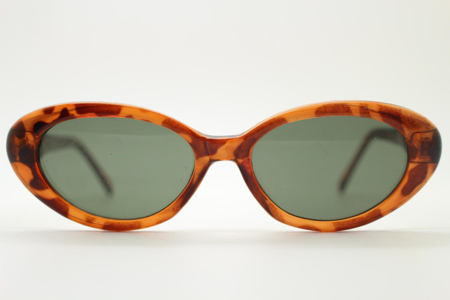 Vintage 90s oval cat eye sunglasses. Vibrant amber tortoise quality acetate frame in neat proportions with green lenses. Womens NOS