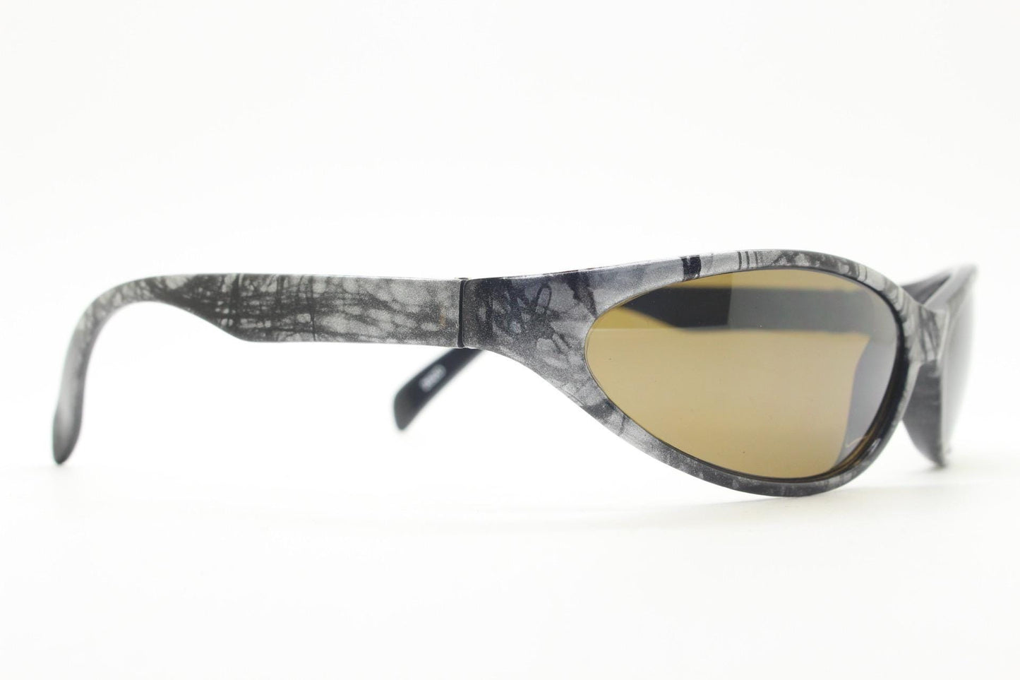 90s vintage sport shield aerodynamic sunglasses. Silver and black marble print wraparound bug eye visor with brown lenses. 2000's. Y2K