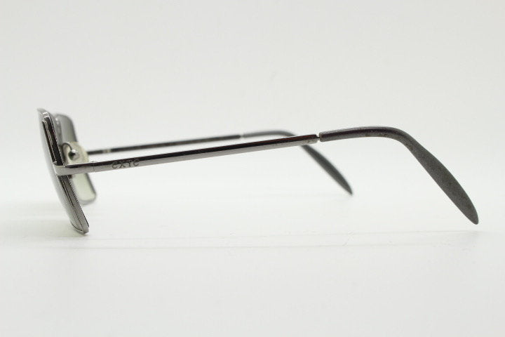 Exte rectangular 90s vintage sunglasses made in Italy. Grey chrome low profile frame with graduating green lenses