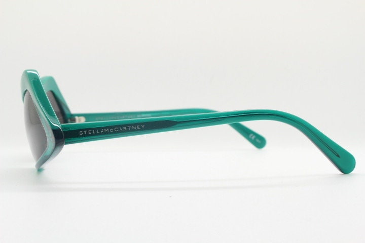 Stella Mc Cartney vintage abstract diamond sunglasses. Blockbuster fashion grail in transparent green acetate with dark lenses. NOS