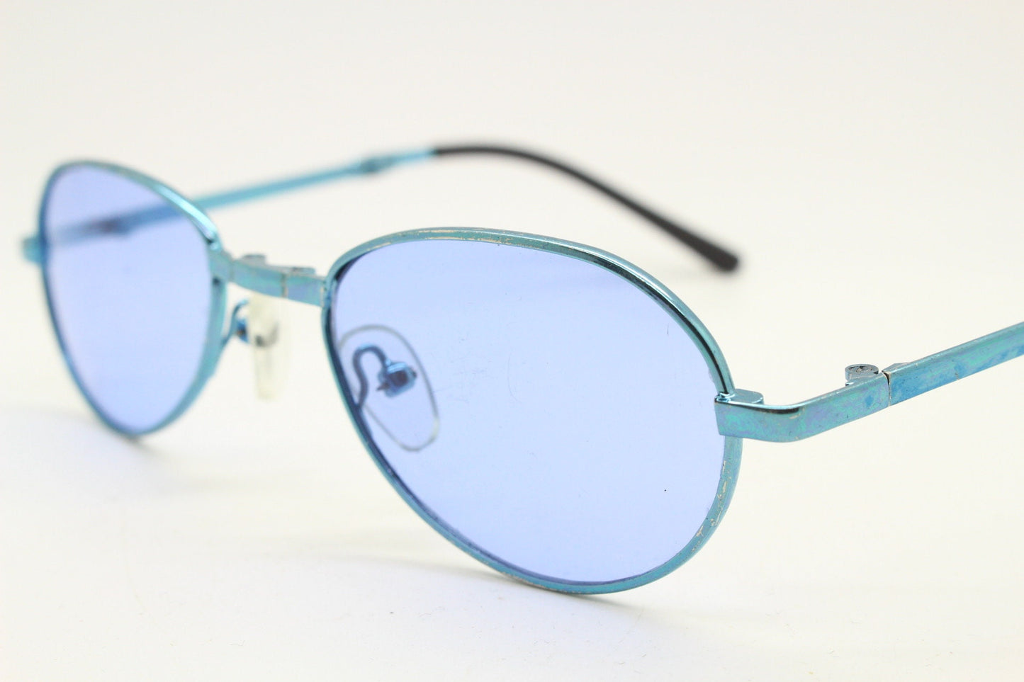 Y2K micro foldable oval sunglasses. Sky lenses in a small folding matching coloured compact frame. Folder. Rave 2000s. 90s NOS