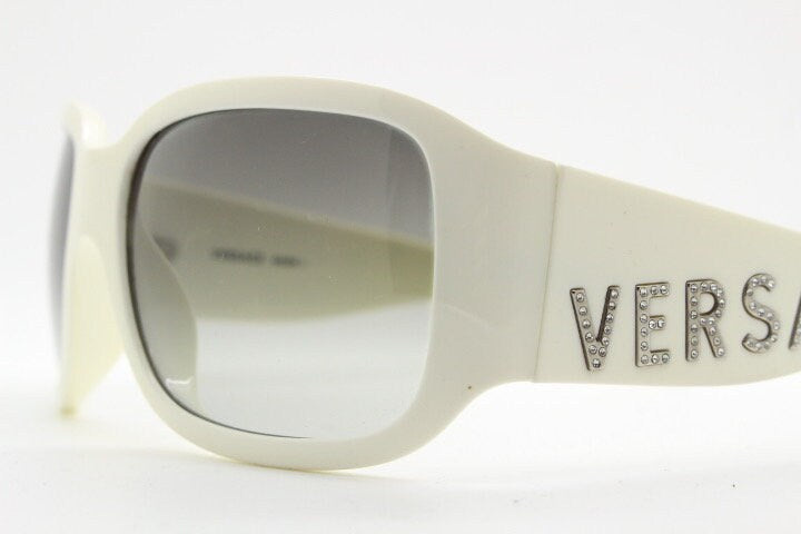Versace Y2k vintage wrap around bug eye sunglasses. Curving white acetate shield frame with huge spell out diamante logo. 2000s. Rhinestone