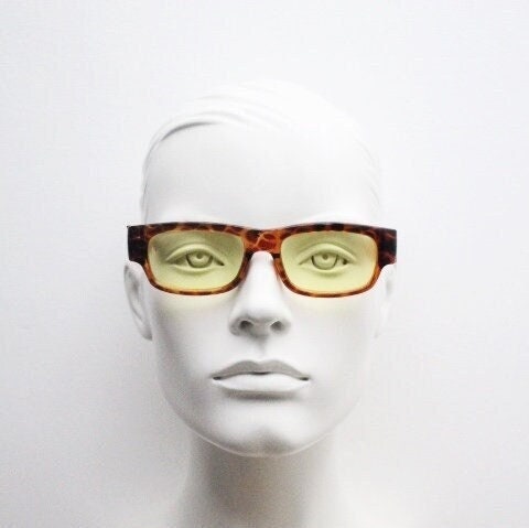 80s vintage rectangular sunglasses. Low profile 60s mod design tortoise frame with psychedelic light tone yellow lenses and fat arms. NOS