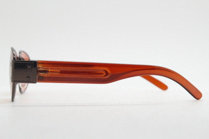 90s vintage low profile sunglasses. Brown chrome frame with thick transparent amber arms and orange lenses. Unused. BNWT