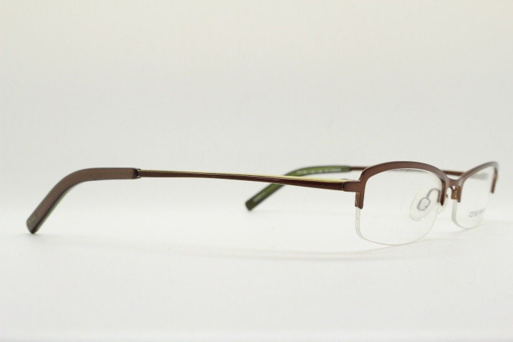 Osiris 90s vintage rectangular half rim eye glasses. Low profile optical frame in handsome brown chrome. Prescription RX Spectacles