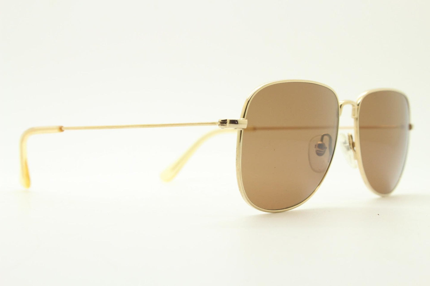 Helmut Lang rectangular 90s vintage sunglasses made in Japan. Minimal gold chrome frame with warm brown lenses. Luxury modified aviator