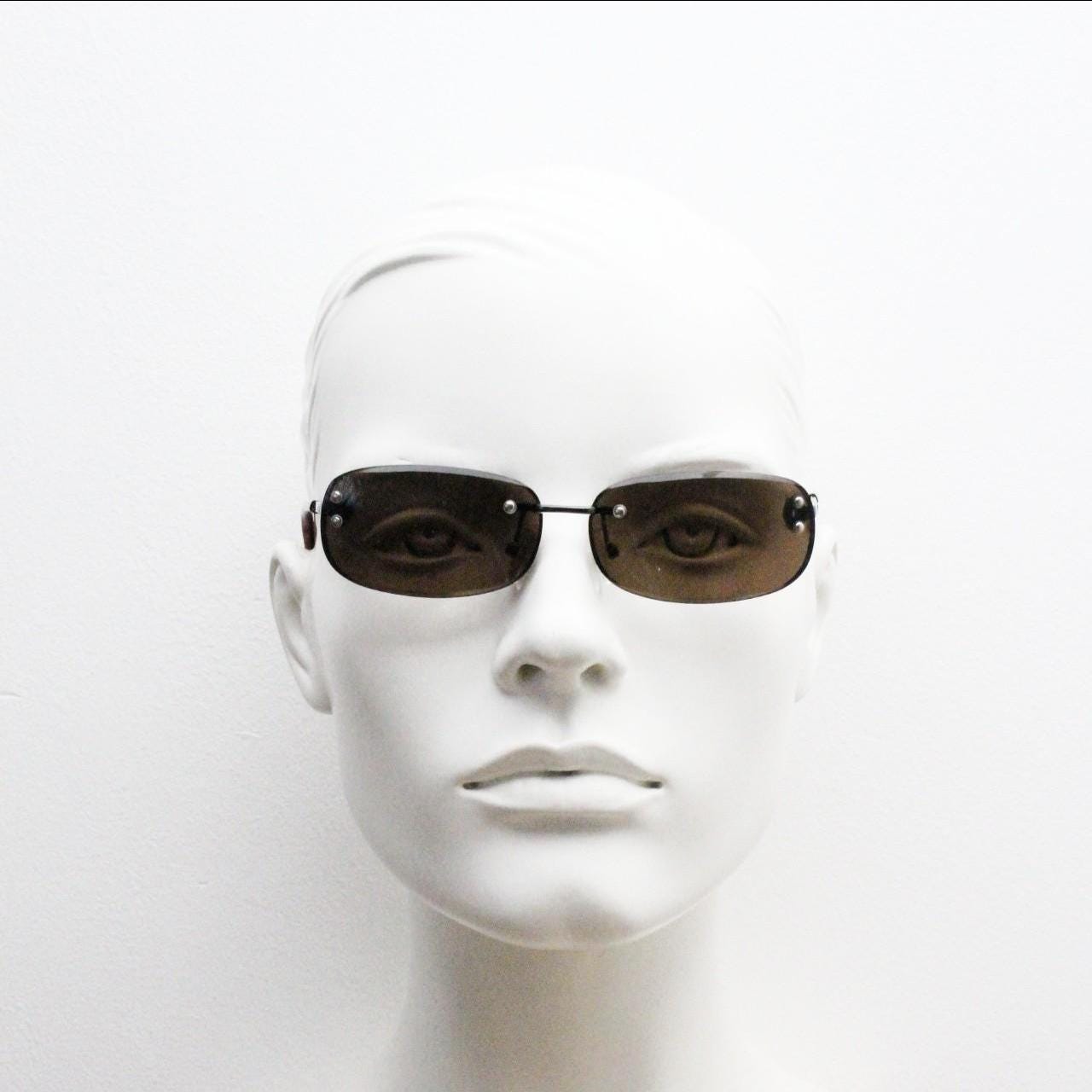 90s vintage minimal frameless sunglasses. Minimal brown rectangular lens with bevelled edges, gunmetal grey trim and tortoise arms. NOS