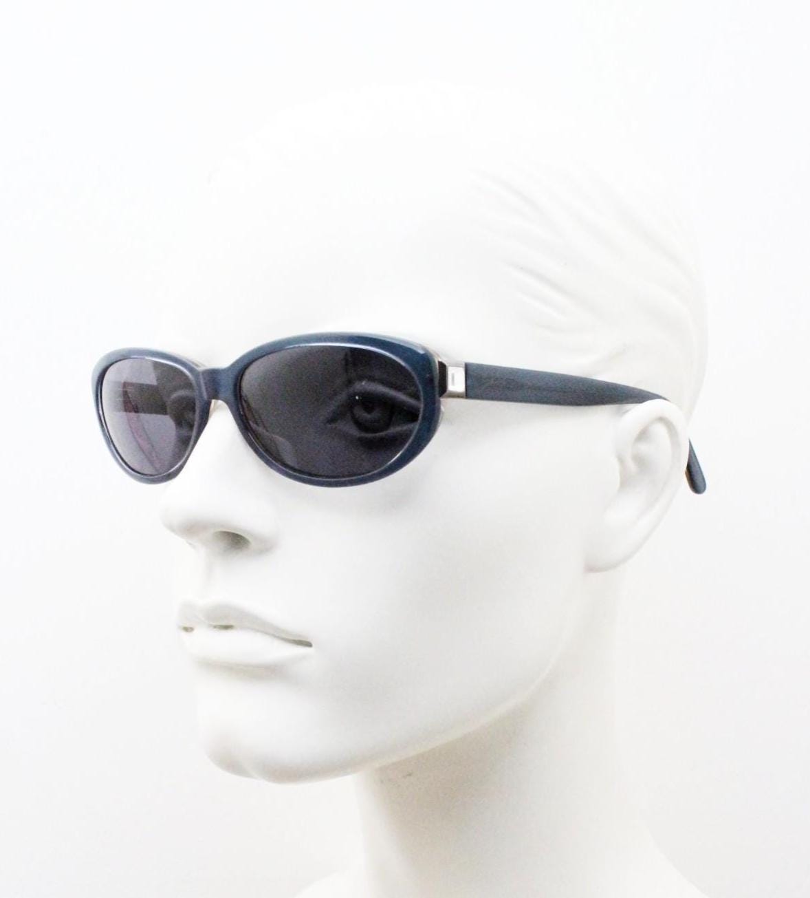 Genny 90s vintage oval cat eye sunglasses made in Italy. Transparent deep blue acetate frame with matching lenses. Womens NOS cateye. BNWT