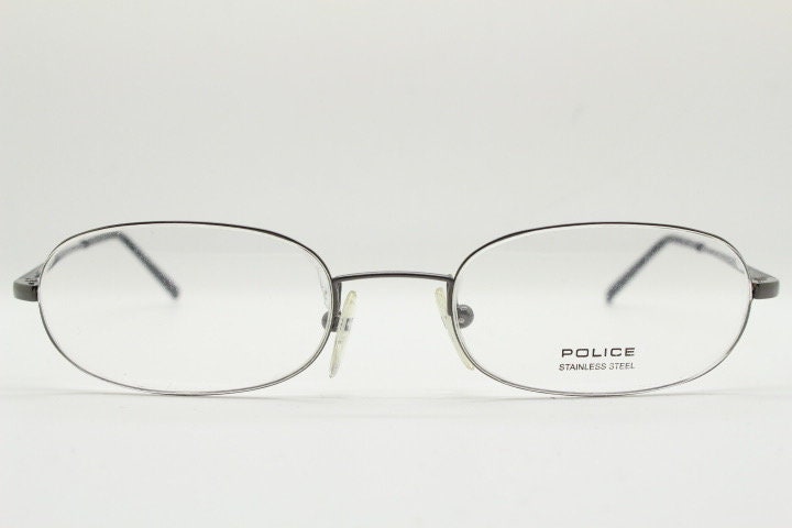 Police 90s vintage oval half rim eye glasses made in Italy. Minimal lightweight optical frame in gunmetal grey. Prescription RX Spectacles