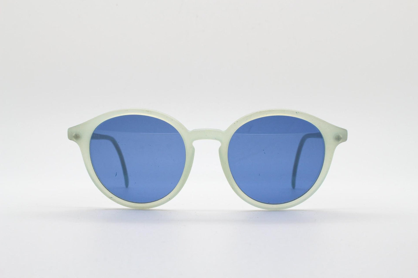 Sergio Tacchini 80s vintage round horn rim sunglasses made in Italy. Transparent pale blue frosted acetate frame with navy lenses. NOS