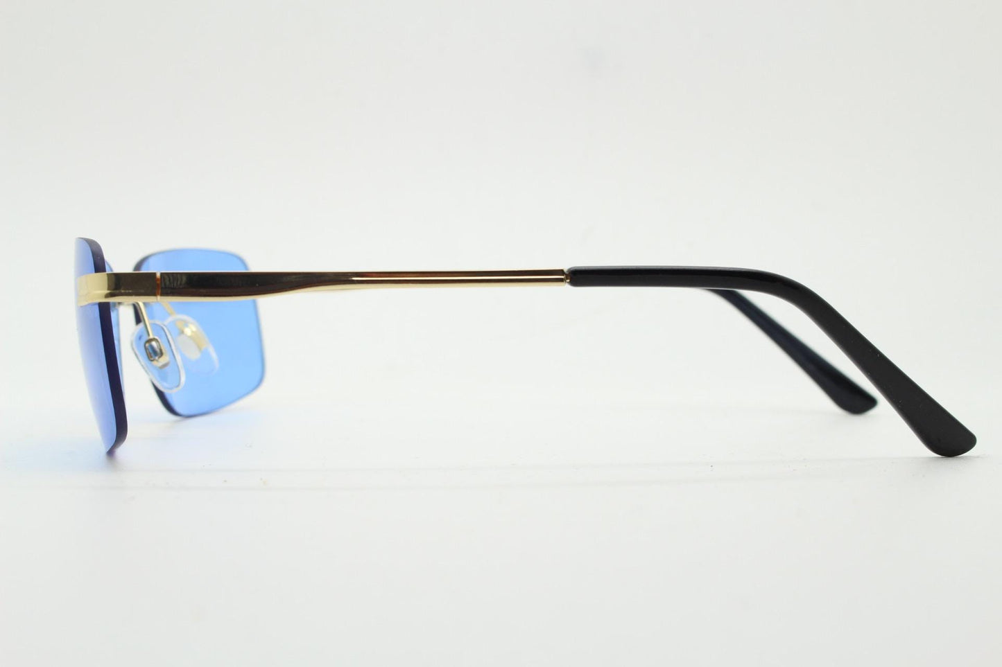 Y2K vintage frameless sky blue sunglasses. Minimalistic rectangular lenses with gold bridge and arms. 2000s club kids. 00's. 90s Rave