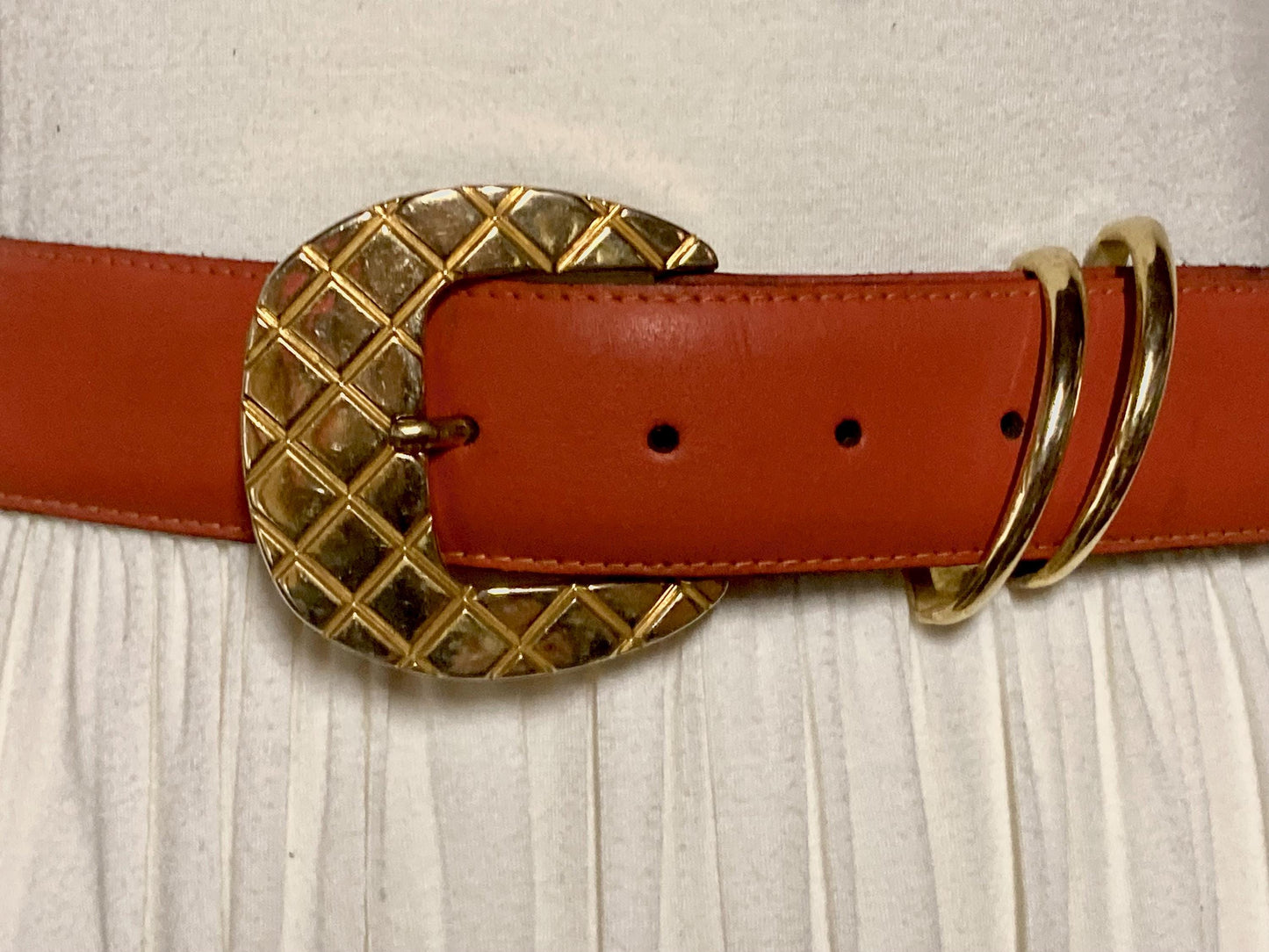80s vintage womens dress / jeans belt in bright orange leather with golden metal squares. Made in France. Used in good condition