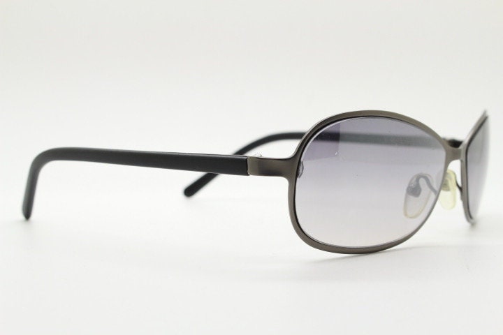 Y2K vintage mini bug eye sunglasses. Curved gunmetal grey flat metal frame with black matt arms and graduating lenses. Unused 2000s NOS