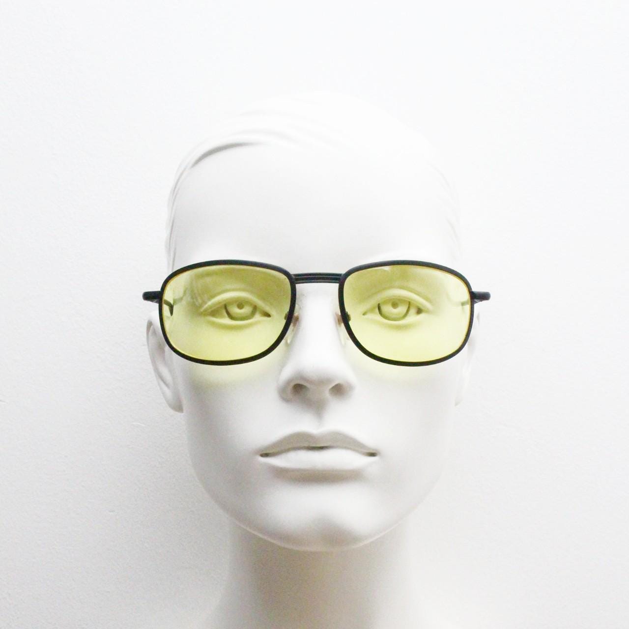 90s vintage oval bug eye sunglasses. Matt black metal frame with blazing yellow lenses and ingenious temple springs. 2000s. NOS