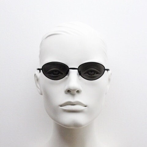 90s vintage oval sunglasses. Minimal plain matt black metal frame with unusual indented arm patterns. Unused NOS