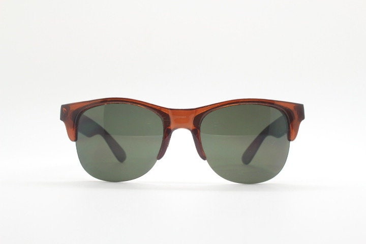 90s vintage modified wayfarer design sunglasses. Transparent brown browline half frame with brown or green interchangeable lenses . NOS