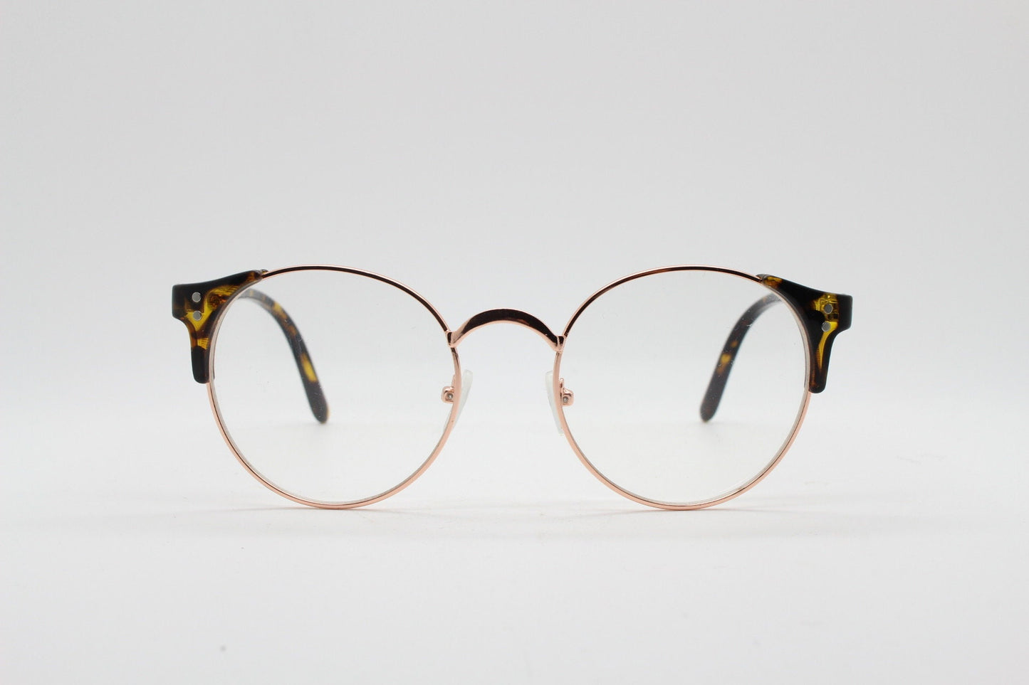 90s vintage modified cat eye glasses. Tortoise arms with a round gold face. 40s, 50s style clear lens eyeglasses. Cateye