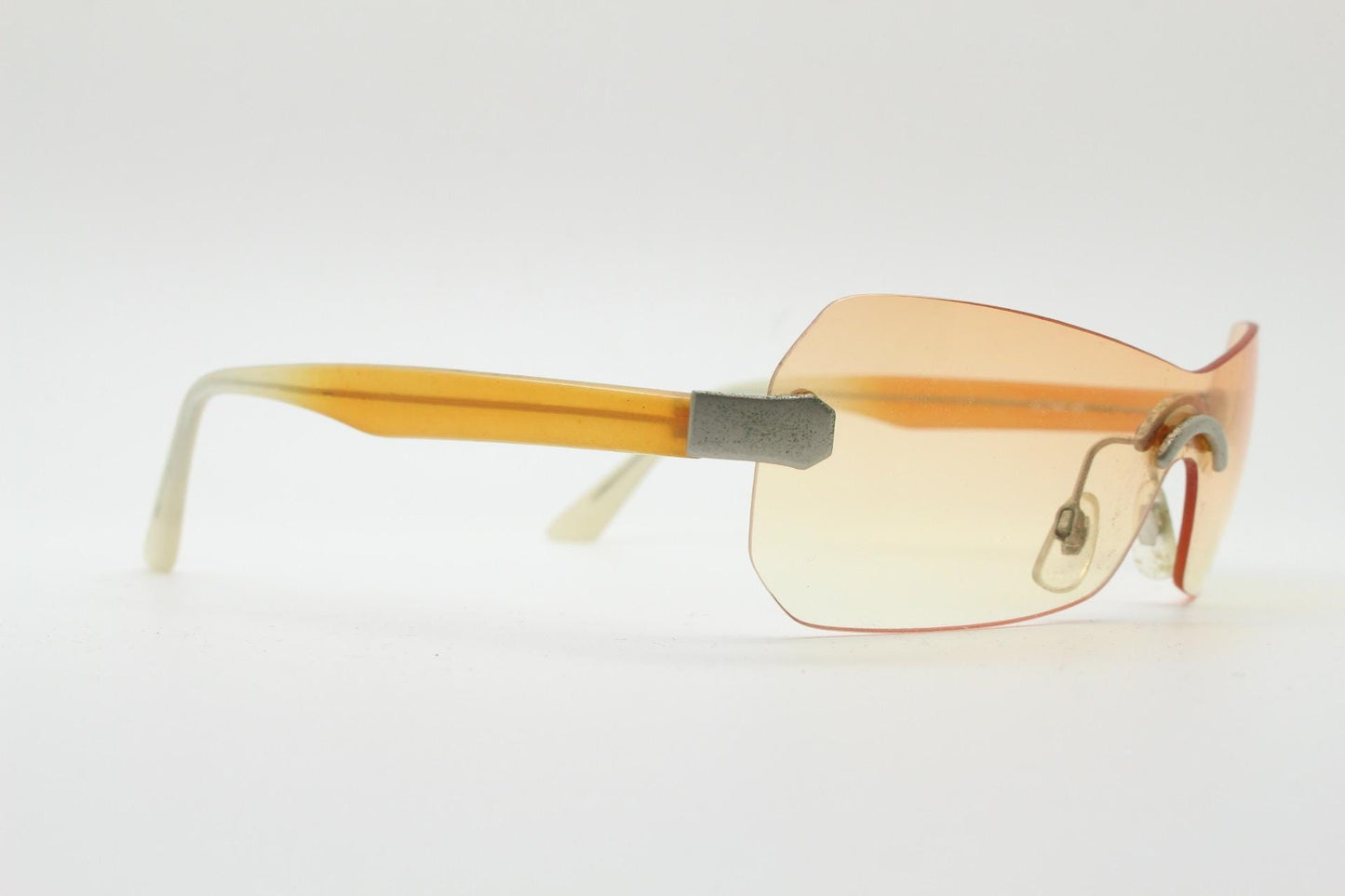 Y2K vintage frameless shield sunglasses. Dynamic 2000's light tone orange mono lens visor with matt silver trim. 00's Cosplay mini mask. NOS