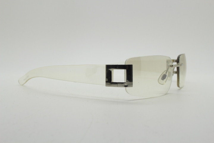 Y2K vintage wraparound sunglasses. Minimal frameless light tone curved mirrored lenses with silver chrome trim. 2000's. 90s. 00s. NOS