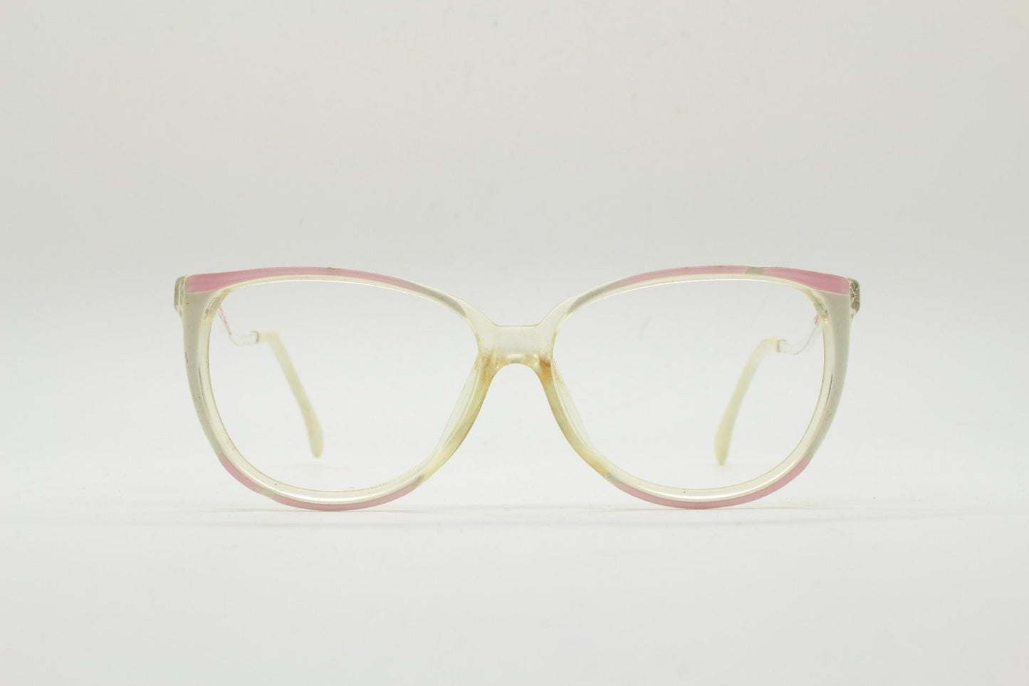 Invicta 80s vintage oversized cat eye glasses made in England. Ice white and pink acetate prescription optical frame with undulating arms