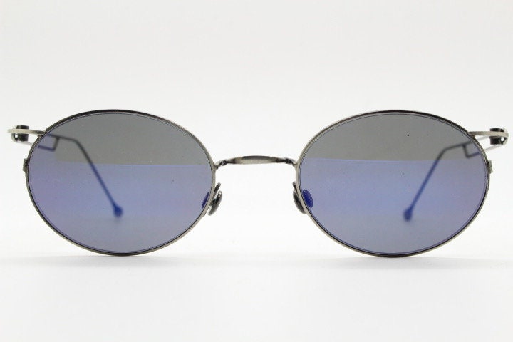 90s vintage oval sunglasses. Refined 'industrial tech' style brushed bronze metal frame with cool blue mirror lenses. Unused NOS