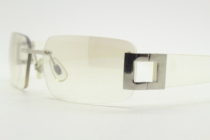 Y2K vintage wraparound sunglasses. Minimal frameless light tone curved mirrored lenses with silver chrome trim. 2000's. 90s. 00s. NOS