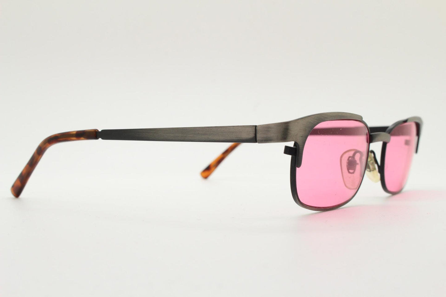 90s vintage rectangular sunglasses with bright pink lenses. Solid metal low profile frame in a brushed bronze finish. Y2K. NOS