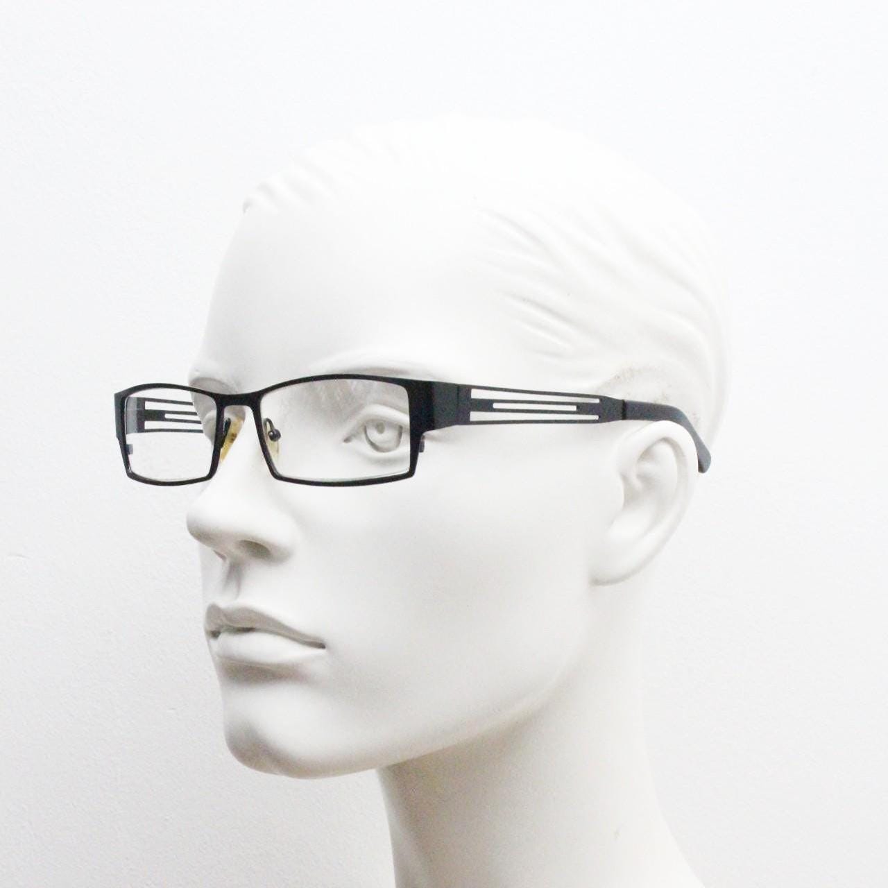 Police 90s vintage rectangular eye glasses model 023. Solid metal optical frame in black satin finish with cut out arm stripes. Prescription