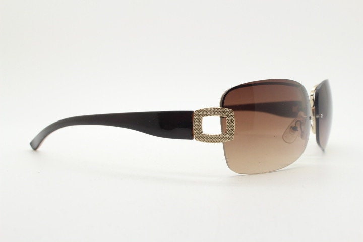 Y2K vintage rectangular brown sunglasses. Gold half frame 2000's wrap around with curved lenses, gold trim and temple crests. Unused NOS