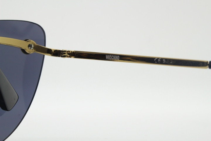 Moschino oval cat eye sunglasses model 082/S. Womens frameless cateye in perfect proportions with golden metal brow line
