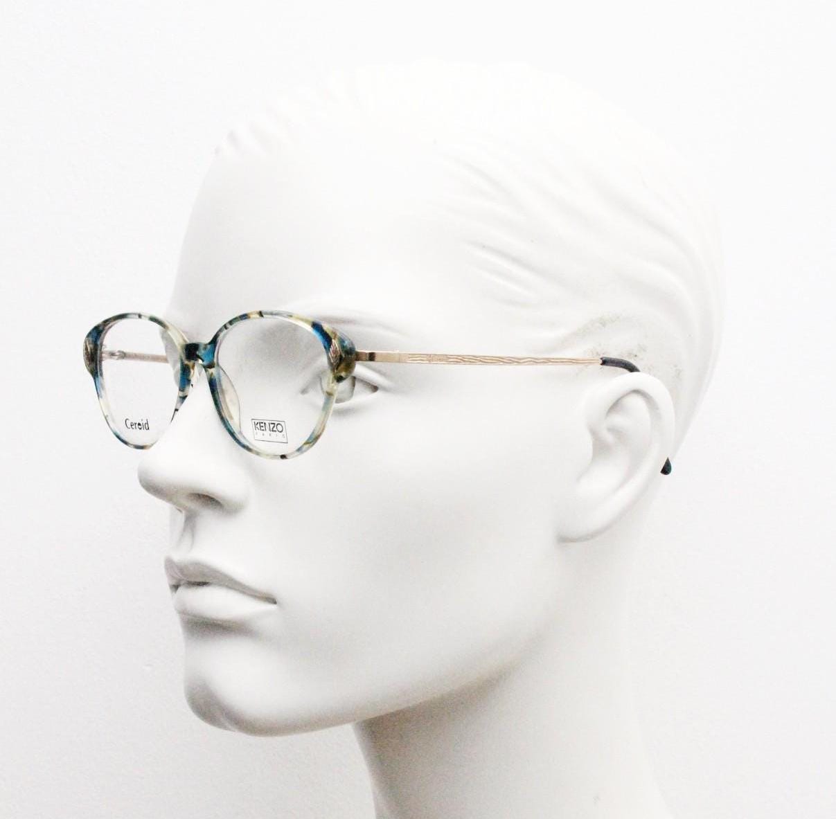 Kenzo 90s vintage cat eye glasses hand made in France. Transparent patterned optical frame with ornate arm details. Womens Prescription. NOS