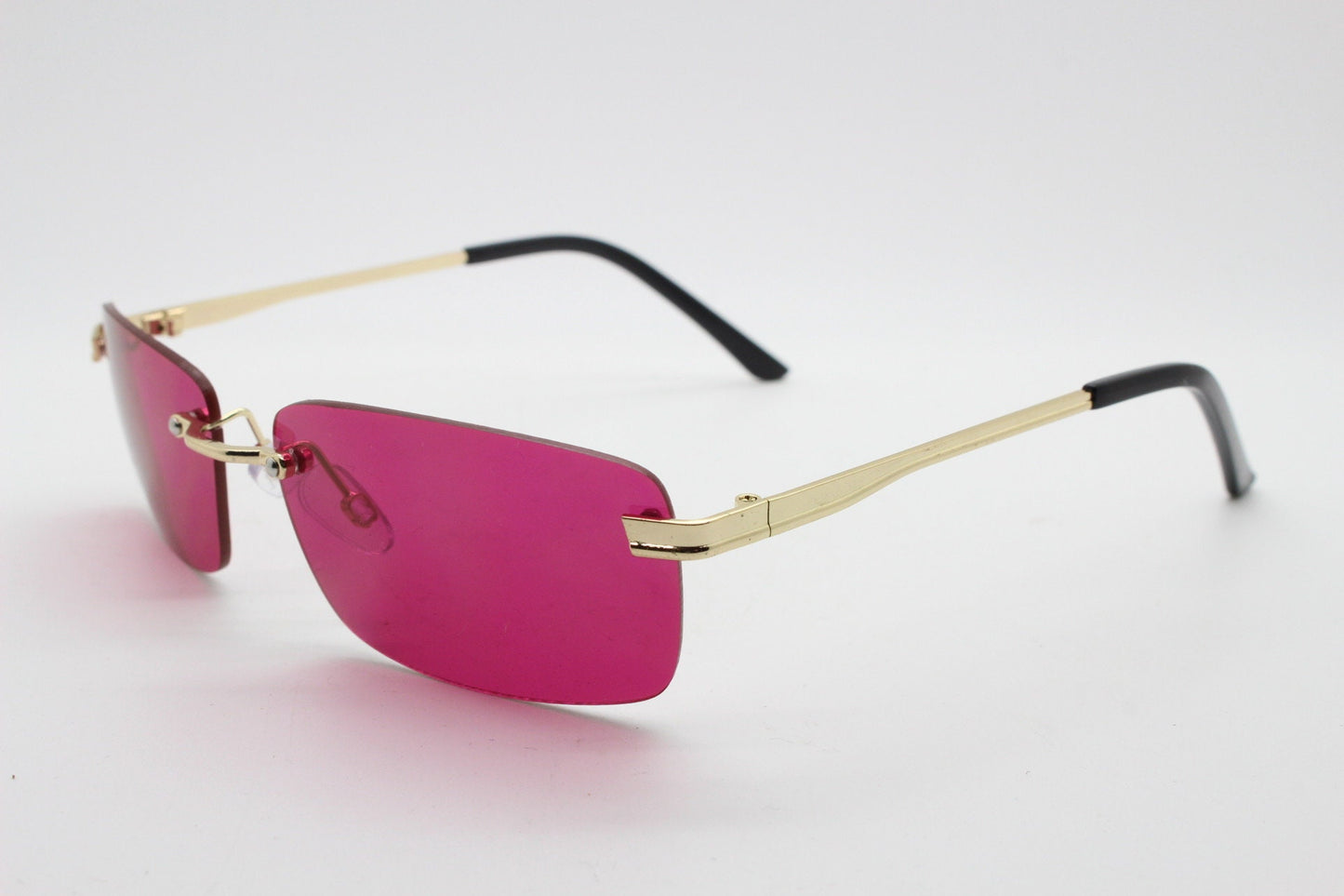 Y2K vintage frameless pink sunglasses. Rectangular lenses with gold bridge and arms. 2000s club kids. 00's. 90s Rave