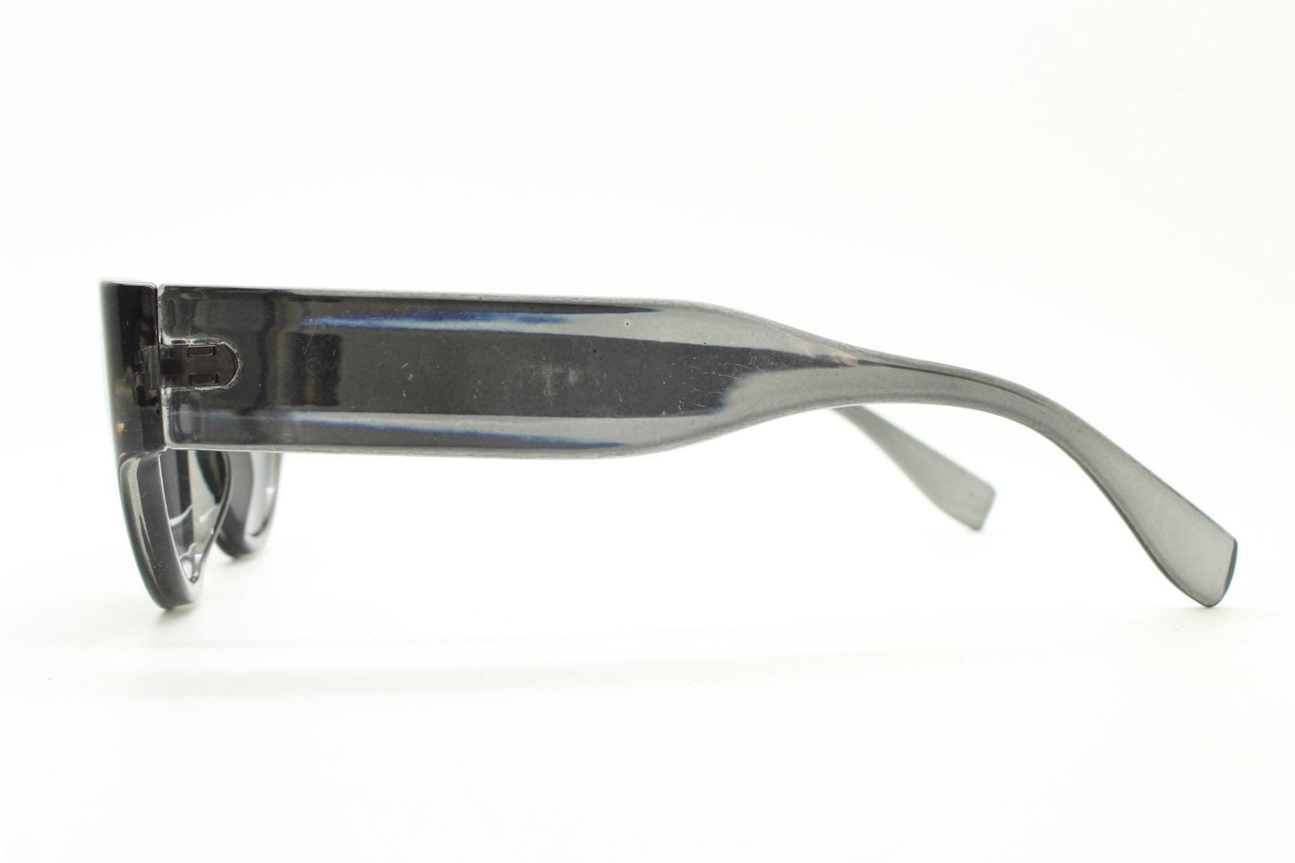 Thick cateye sunglasses with cropped sides and sharp outline. Womens 60s design chunky transparent grey frame and lenses. Y2k vintage