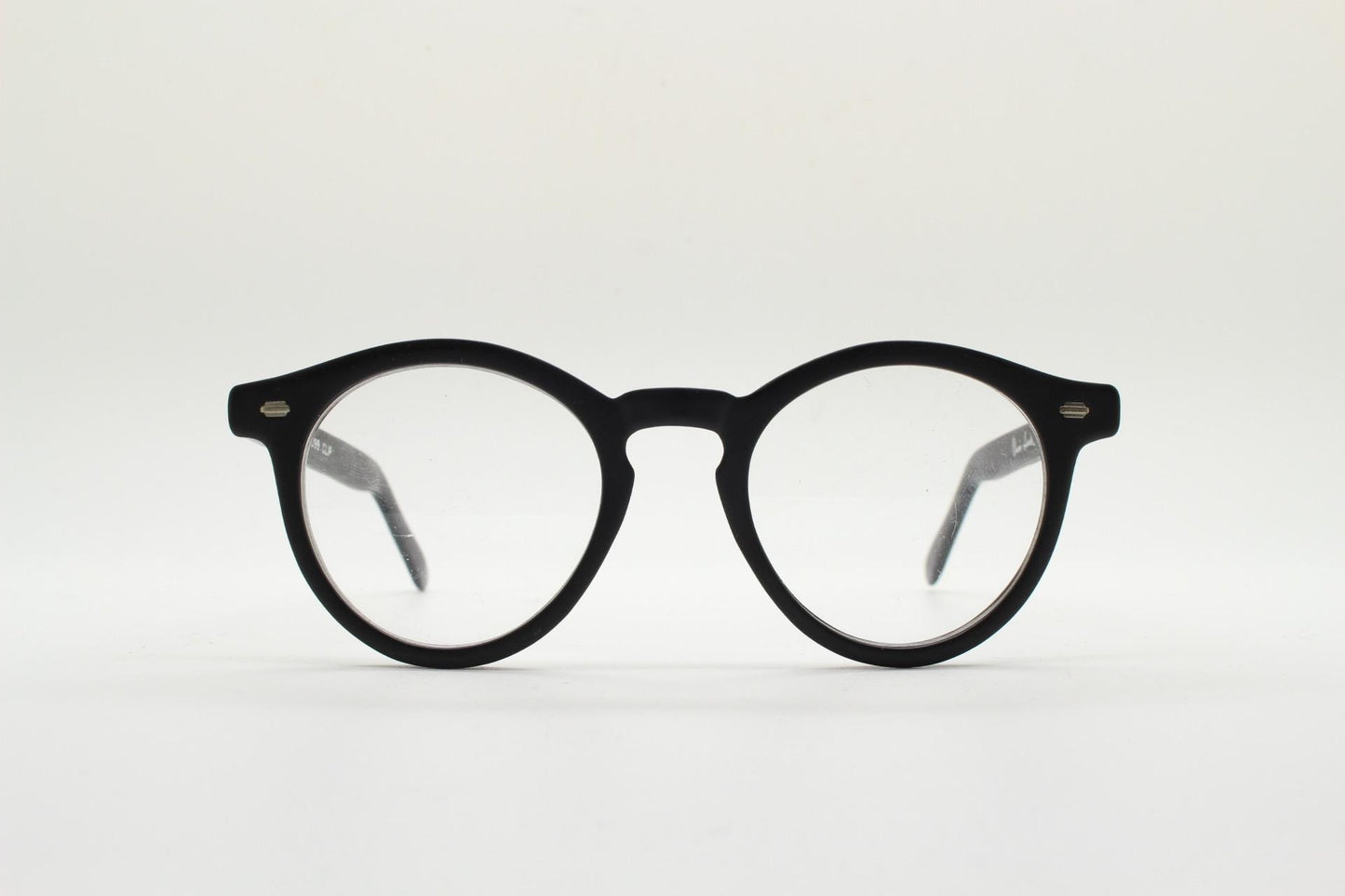 Oliver Smith round eye glasses. Black matt finish optical frames with protruding corners and keyhole bridge. Prescription RX eyeglasses