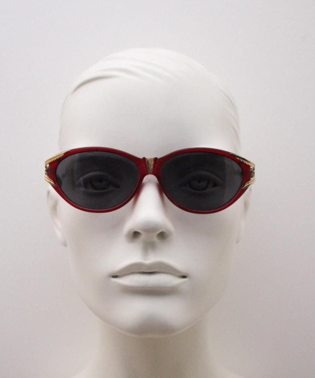 80s vintage Revlon cat eye sunglasses. Women's dark pink transparent frosted frame with golden Y fork ornate temples. 90s cateye. NOS