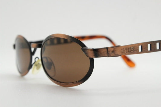90s vintage oval sunglasses. Handsome metallic brushed copper finish with arm cut outs. Unused NOS