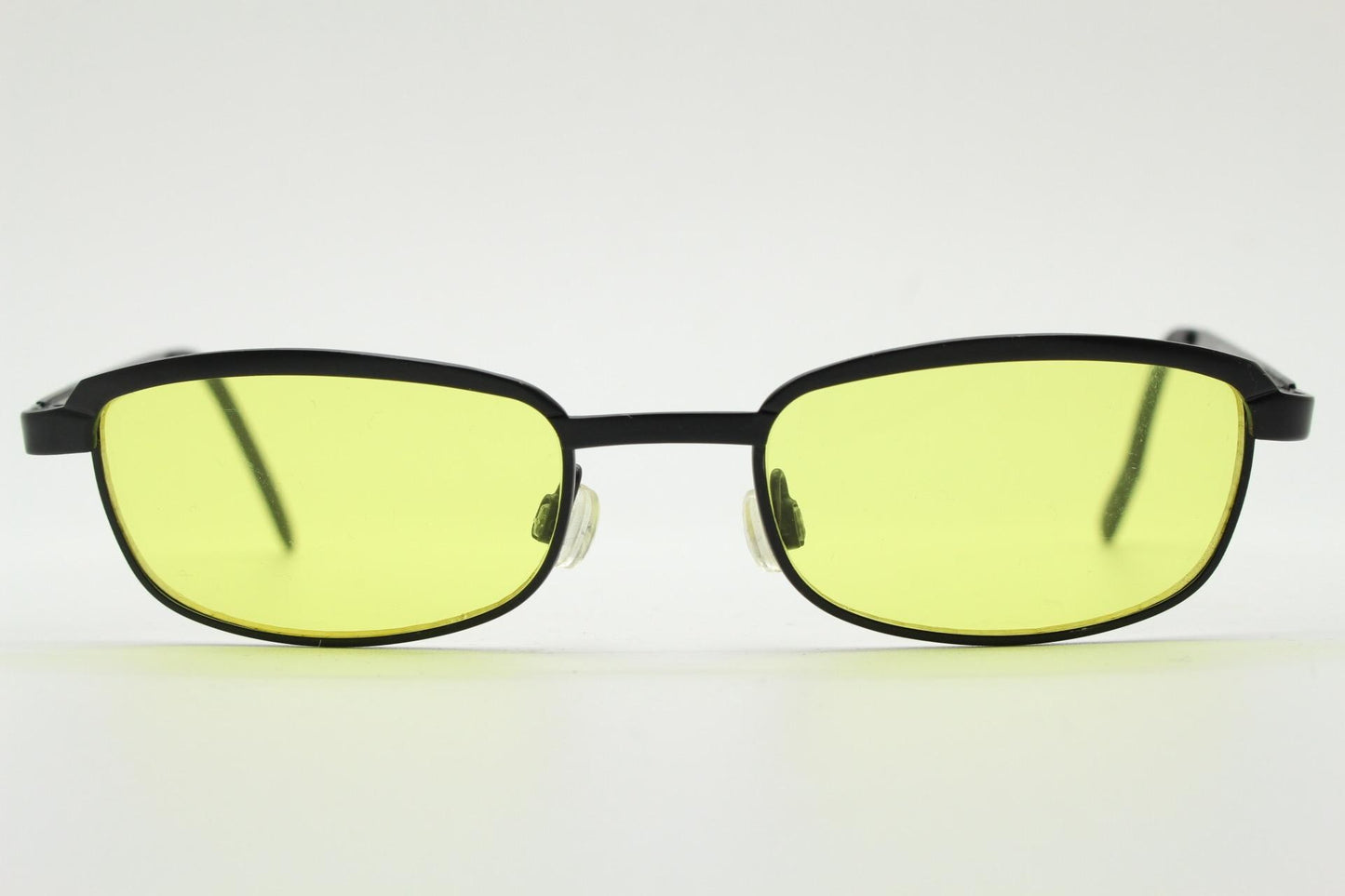 Vintage small rectangular sunglasses. Authentic quirky 90s design in a matt black solid metal frame with bright yellow lenses. 2000s. NOS